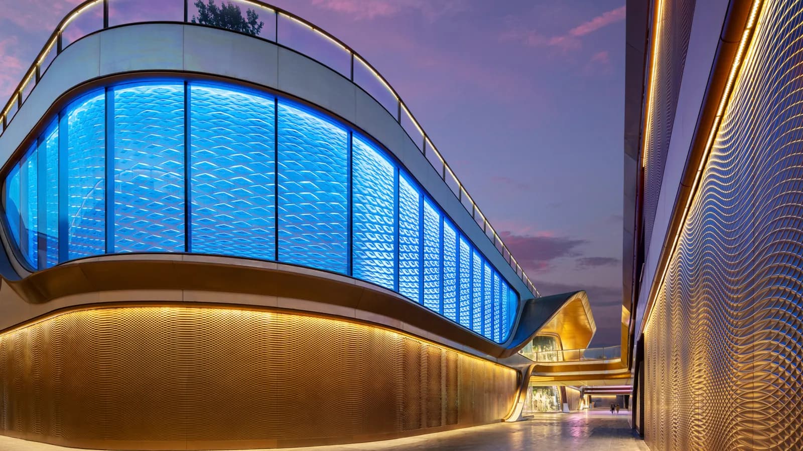 The illuminated blue diamond-patterned GRG feature wall at SKP Chengdu at dusk.